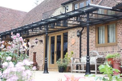 Black Classic Victorian-style garden veranda with ornate brackets