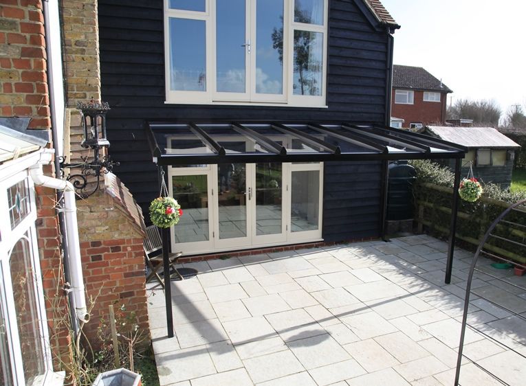 Contemporary black Nouveau glass veranda over a patio